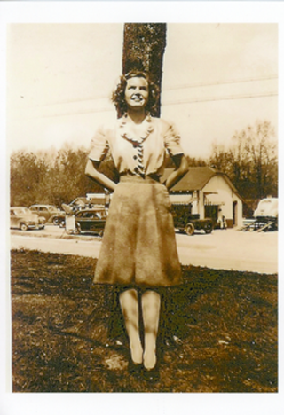 Young woman in front of tree